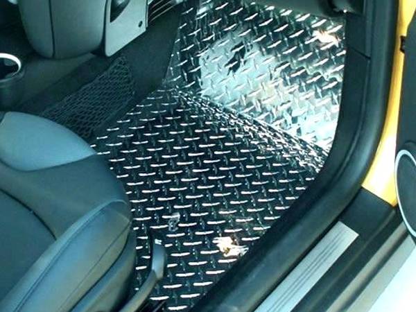 Inside a Mini Cooper, polished aluminum diamond plate floor replacing rubber floor mat