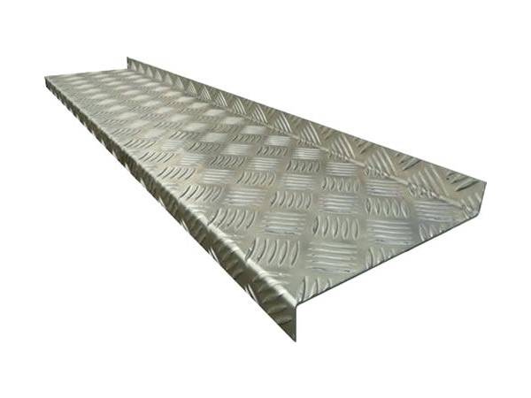 A piece of non slip stair tread is made of aluminum checker plate.